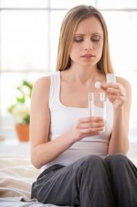 Woman taking aspirin.